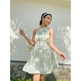 Sleeveless organza halter mini dress with tie-back detail and softly flared skirt